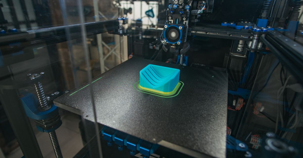 close up of a 3d printer creating a plastic object in an industrial setting